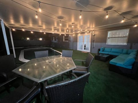 Partially covered backyard with comfortable patio lounge furniture and a pool for spending time with family