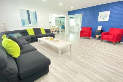 Roomy, stylish, and modern living room with plenty of comfortable seating for large families and a smart TV