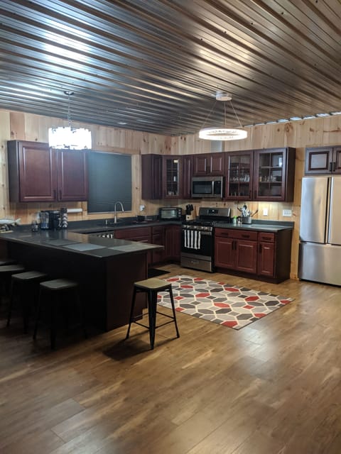 Large kitchen with a large counter for seating. 
