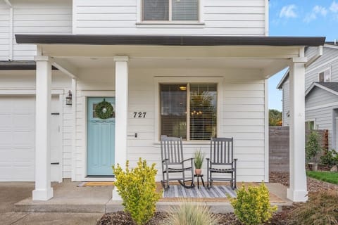 Two rocking chairs out front as you look out into a park and wineries.
