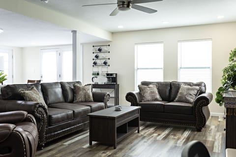 Living Room with love seat, couch and recliner to sit and relax on.