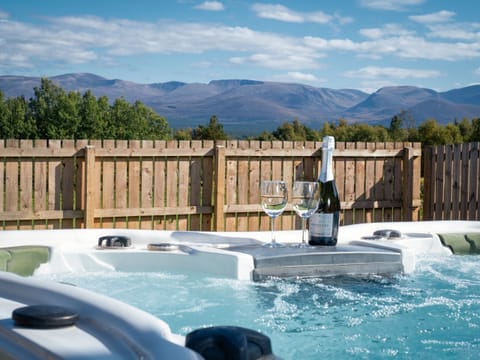 Take in the stunning view of The Cairngorms from the hot tub