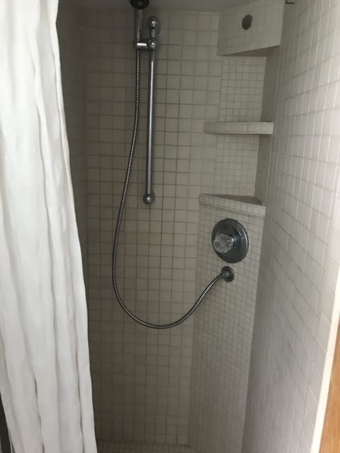 A very low shower as an add on by the original owner We hope to replace soon
