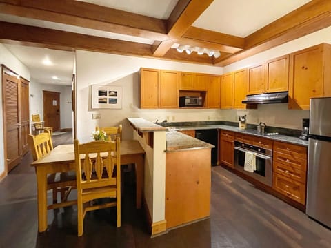 Kitchen, dining, and hallway to front door of unit. 