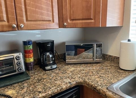 Microwave, dishwasher, coffee/tea maker, cookware/dishes/utensils