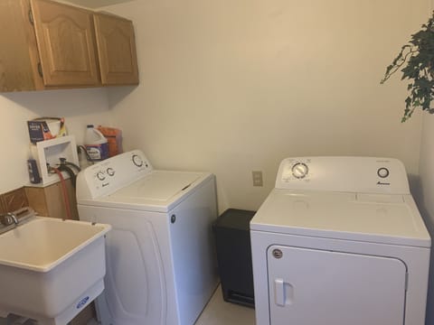 Full size washer and dryer with slop sink just off the kitchen.