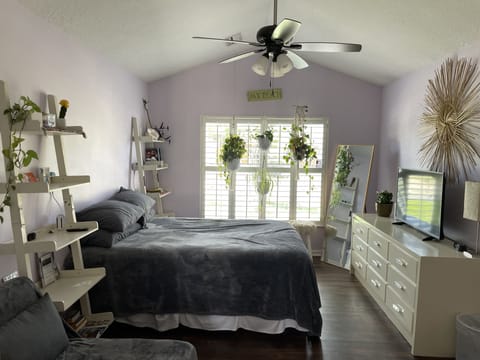 Spacious bedroom with lots of light and plants.  Wooden shutter blinds.  Comfy…