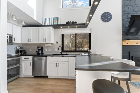 Updated full-size kitchen with stainless steel appliances and new countertops.