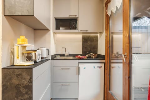 Practical kitchen next to the balcony access