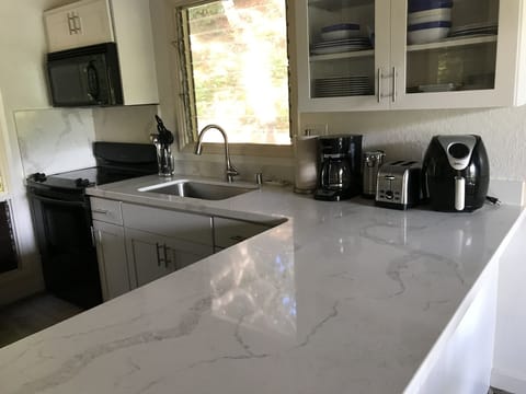 kitchen has all the small appliances found in most homes & quartz countertops