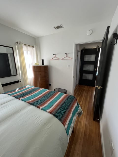 Bedroom 2 has a dresser and clothing hangers