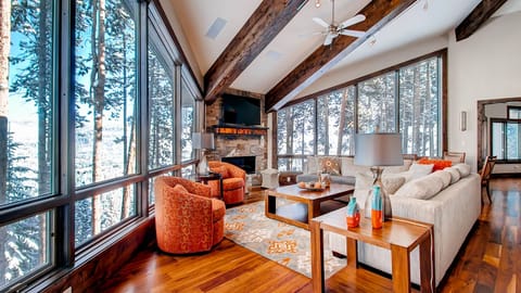 Great room with fireplace and wooded views