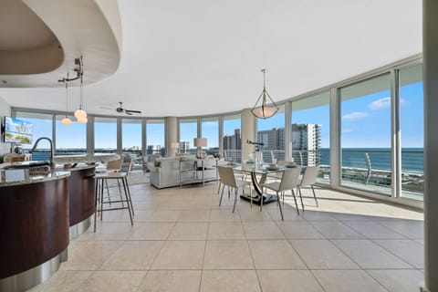 Spacious and inviting living area with floor-to-ceiling windows showcasing breathtaking panoramic views. This open-concept design seamlessly blends comfort and style, creating the perfect space for relaxation and entertainment.