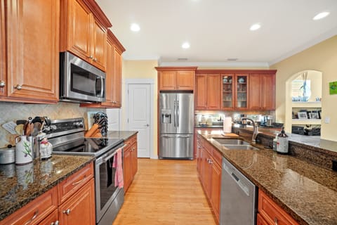 View of the kitchen from the dining room. Already stocked with most items.