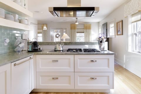 This bright and sunny kitchen offers a Wolf cooktop with three gas and two induction burners.  