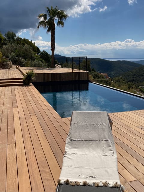 An infinity pool, a heated pool, sun loungers