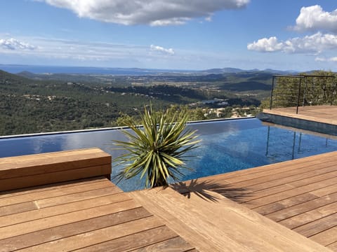 An infinity pool, a heated pool, sun loungers