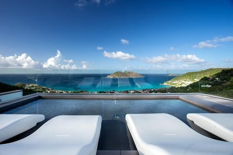 An infinity pool, a heated pool, sun loungers