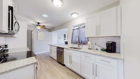 Modern Kitchen fully equipped with appliances, cookware, tableware, cutlery and a stocked Keurig