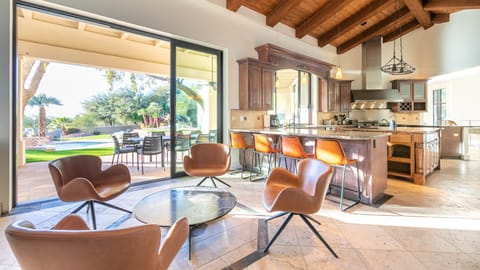 Spacious open-plan living area with modern kitchen and seamless outdoor flow.