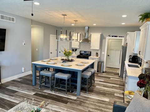 Large island table doubles as kitchen seating and family gathering point.