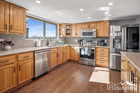 - Fully equipped kitchen featuring wood cabinetry, stainless steel appliances, & hood
- Mosaic tile backsplash adds texture while windows bring in fresh morning light
- Extra counter space makes this kitchen ideal for home cooked meals & gatherings