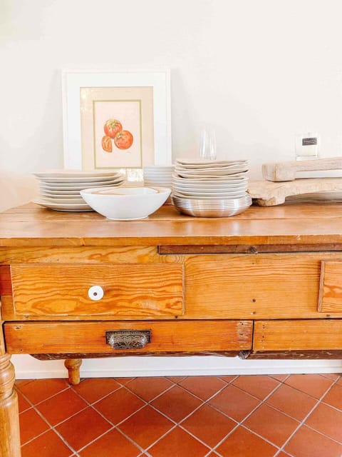 Plenty of plates, silverware, family art, and vintage furniture.