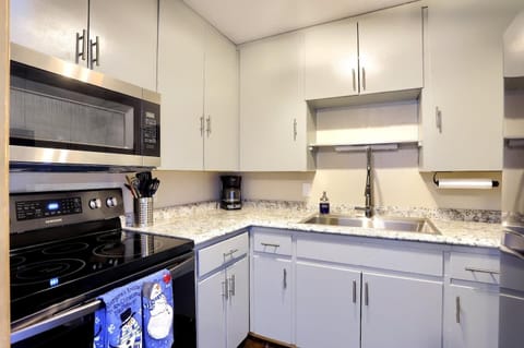 Fully equipped kitchen with smooth granite countertops and stainless appliances
Ample cabinet space and modern pull-down faucet for cooking convenience
Perfect spot to prepare meals with everything neatly within arm’s reach