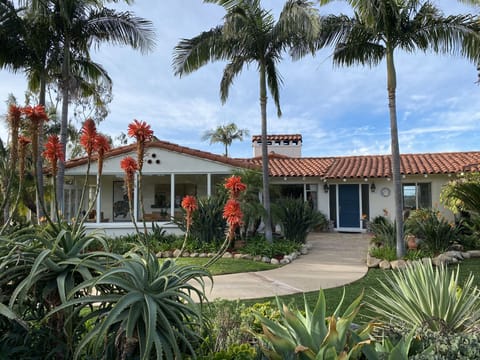 The front entrance w/ single-story living for the main home.