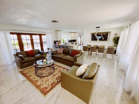 Living Area with comfortable leather couches and large Smart TV. 