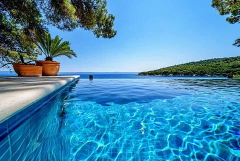 An infinity pool, sun loungers