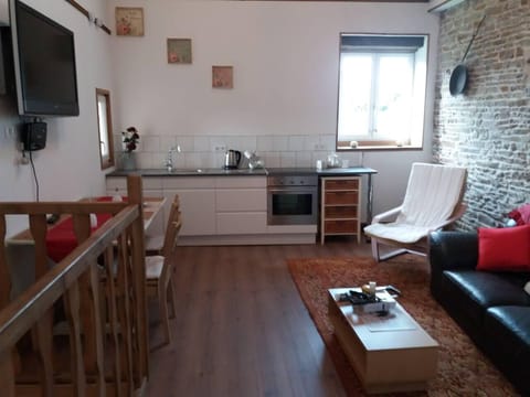 The kitchen area has a cooker, fridge and utensils along with a toaster, kettle and coffee machine