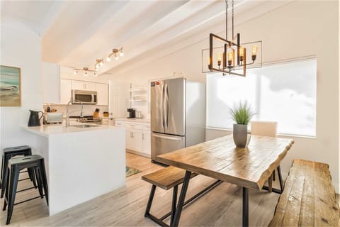 Bright dining and kitchen area is at far end of great room.