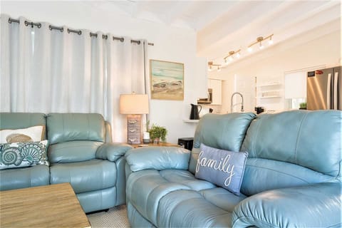 Living room has comfortable leather sofas.