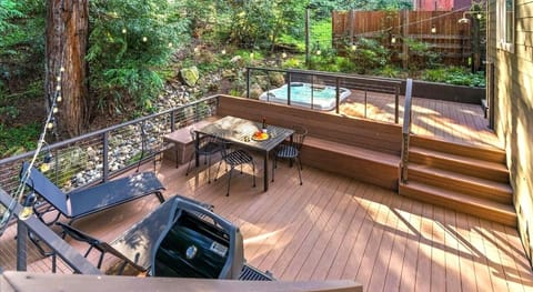 Enjoy the hot tub on this expansive deck surrounded by redwoods