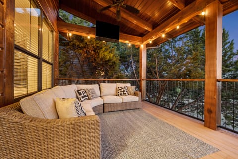 HUGE patio with ambient lighting, tons of couch space, smart tv, and dining area