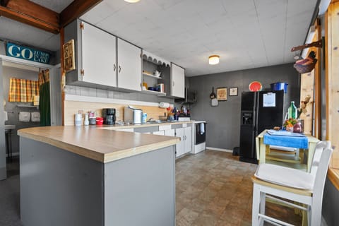 Refrigerator/freezer,  ice maker. microwave, dishes, cooking utensils, wine glas