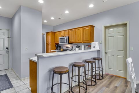 Kitchen with bar area and 4 bar stools