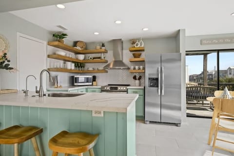 This kitchen is fully equipped with a breakfast bar, appliances, and an abundance of cabinet and counter space! You'll have everything you need in a kitchen, while enjoying your vacation.