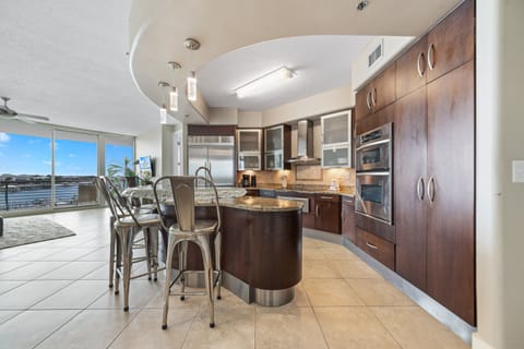 The modern kitchen island with bar seating offers a casual dining option, while the open layout maximizes natural light and showcases the stylish finishes throughout.