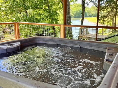 Want to wind down in this hot tub and relax? Relax in the hot tub and hear the river in the background. This is one of the only waterfront homes with a hot tub in the area.