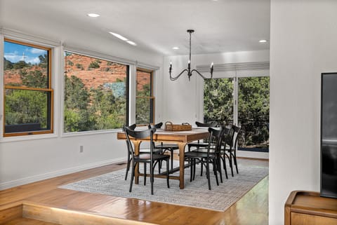 Adjacent to the kitchen, the dining table and offers a perfect spot to enjoy meals with vibrant views.