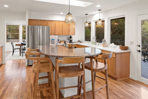 Fully Equipped Kitchen w/ Center Island & Dining Area in Background