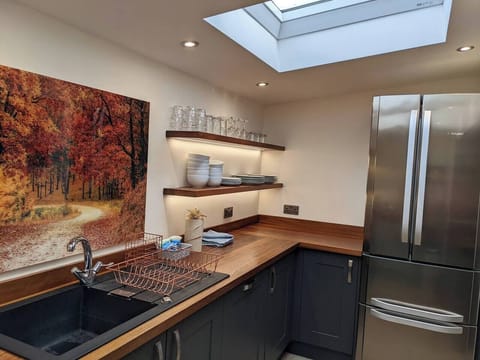 Modern & stylish kitchen fully equipped for self-catering with everything you need including an American style fridge freezer