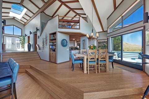 Dining area with a table that seats 6-8 people and an open floor plan.