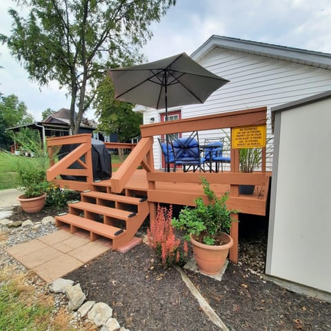 Deck with seating for 4, a table and gas grill.