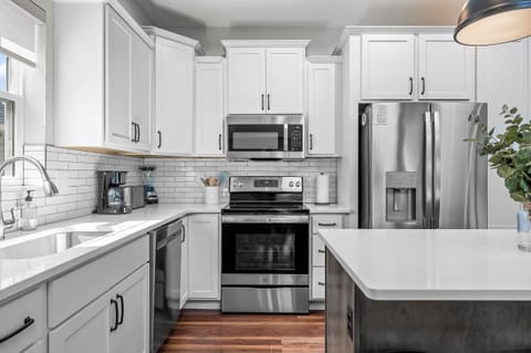 Stainless appliances with lovely cabinets