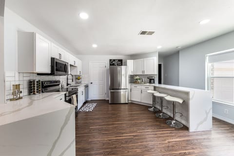 Fully stocked kitchen with waterfall quartz countertops