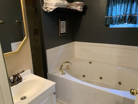 Bathtub, jetted tub, hair dryer, towels