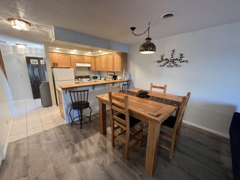 Large table comfortably seats 4 with two barstools at the bar!